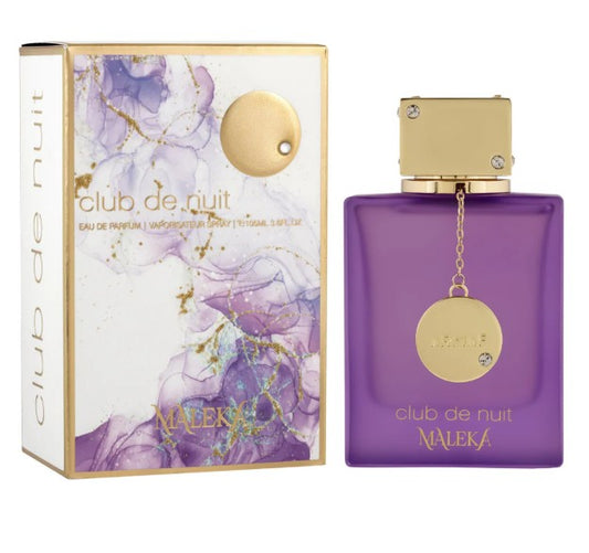 Purple eau de parfum bottle with gold lid and round medallion charm, boxed set