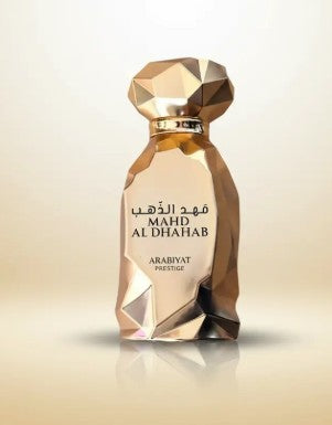Gold faceted perfume bottle with dark cap, label marked MAHD AL DHAHAB