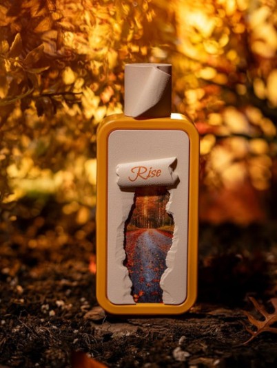 Orange glass Eau de Parfum bottle with 'Rise' label, 100ml