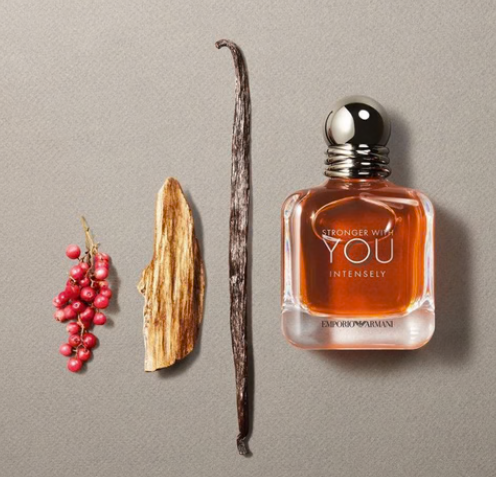 Amber fragrance bottle with chrome cap and square glass design, centered label