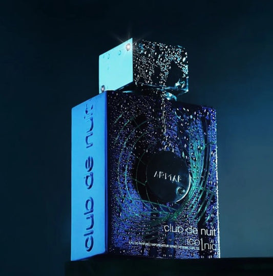 Blue eau de parfum bottle with cap shown with product box in dark background