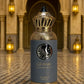 Blue and gold eau de parfum bottle with ornate cap and decorative label
