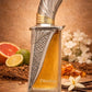 Perfume bottle with metallic cap and silver textured strip, amber liquid in view.