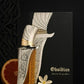 Perfume bottle with metallic cap, textured silver panel, and amber liquid.