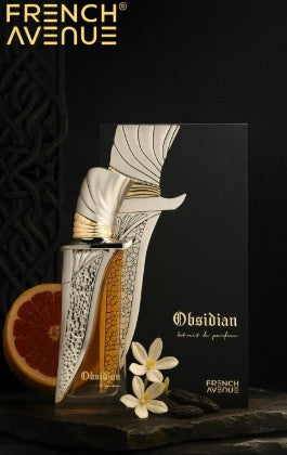 Perfume bottle with metallic cap, textured silver panel, and amber liquid.