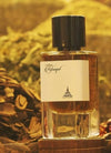 Eau de parfum bottle with black cap and amber liquid, front label visible.