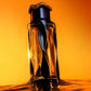 Teriaq Intense eau de parfum bottle with dark glass and amber-tinted highlights