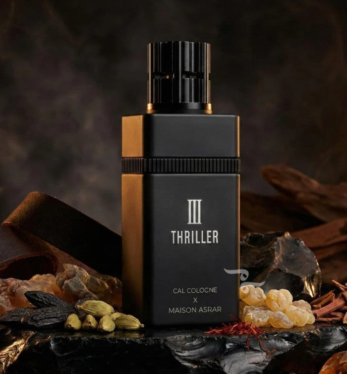 Perfume bottle with black and gold cap, 'III THRILLER' label, Maison Asrar