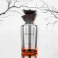 100ml perfume bottle with metallic silver glass and amber liquid, wide spray cap