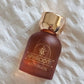 Maroon fragrance bottle with gold cap, label APHRODITE MYKONOS