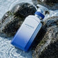 Blue extrait de parfum spray bottle with MYKONOS label and silver cap