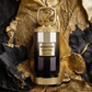 Perfume extrait de parfum bottle with gold cap on dark and gold rock texture
