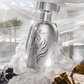 Translucent silver extrait de parfum bottle with metallic cap and black emblem