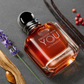 Angled view of amber fragrance bottle with chrome cap and clear square glass base