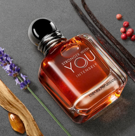 Angled view of amber fragrance bottle with chrome cap and clear square glass base