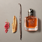 Amber fragrance bottle with chrome cap and square glass design, centered label