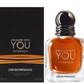 Amber fragrance bottle with chrome cap next to product box, 'Stronger with You Intensely'