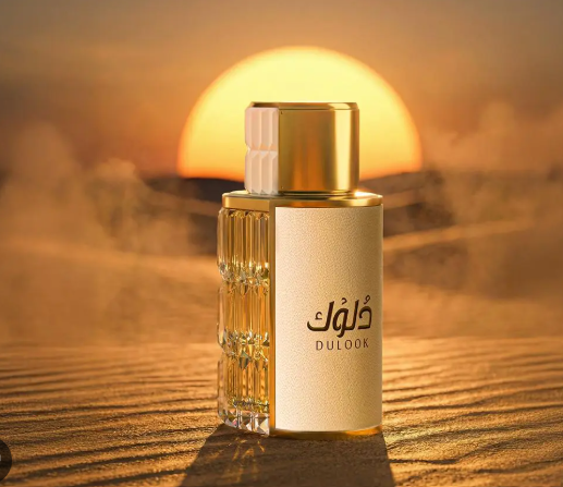 Gold and white perfume bottle with tall faceted amber glass detail