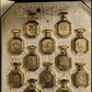 Gold hexagonal perfume bottles set in decorative gift box with glass vials