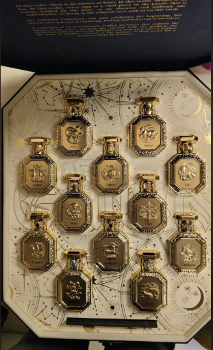 Gold hexagonal perfume bottles set in decorative gift box with glass vials